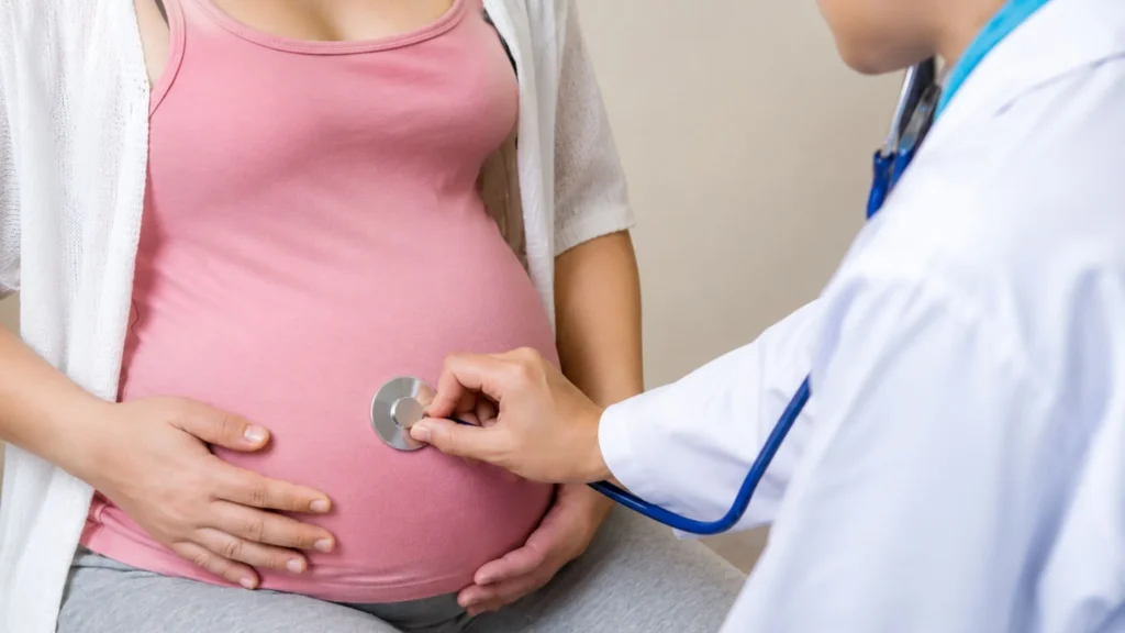 Maternity care hospital in Thrissur doctor checking pregnant woman with stethoscope