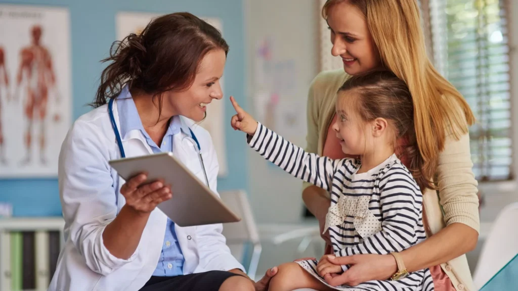 Advanced Pediatric Care Hospital in Thrissur showing pediatric doctor interacting with child and mother during consultation