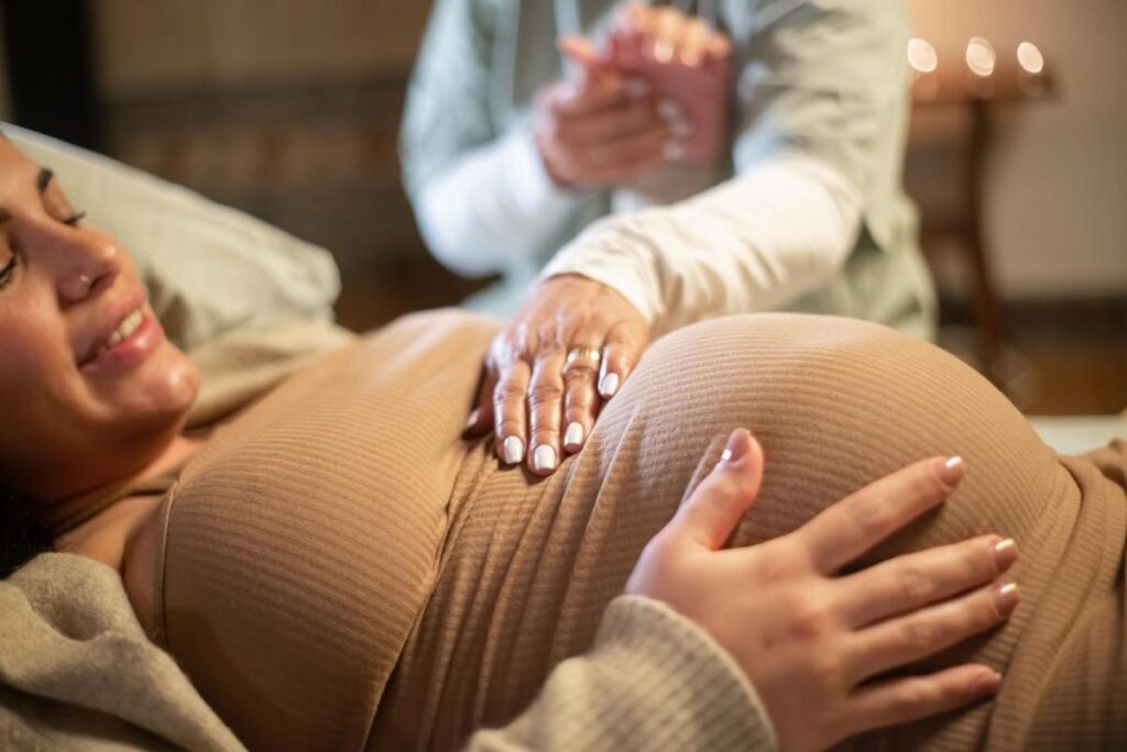 Pregnant woman receiving compassionate maternity support during labor as part of Choosing the Best Maternity Care in Thrissur.